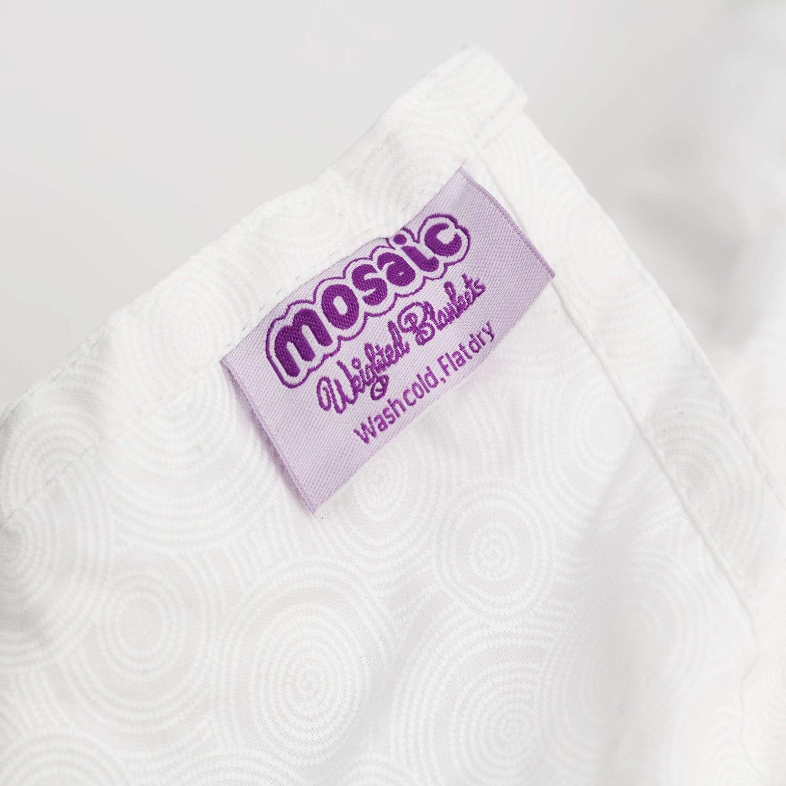 Close-up of the Mosaic label and cotton fabric